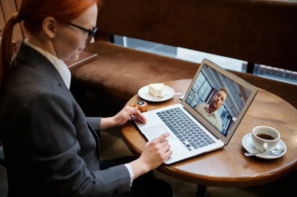 a manager having a meeting on zoom, one of the considerations for global businesses