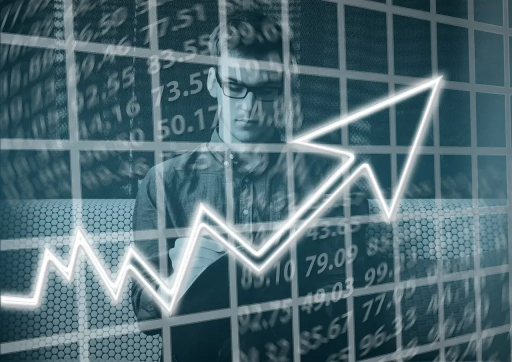 a photo of a man behind a chart that shows business growth, one of the many advantages of taking on a strategic ally