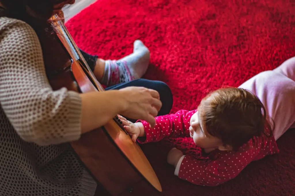 mother learning a guitar, showing that learning does not stop at any age