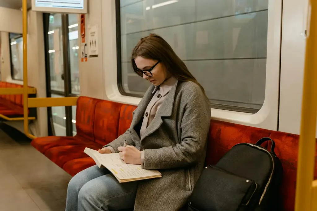 woman reading while commuting, a dedication to lifelong learning