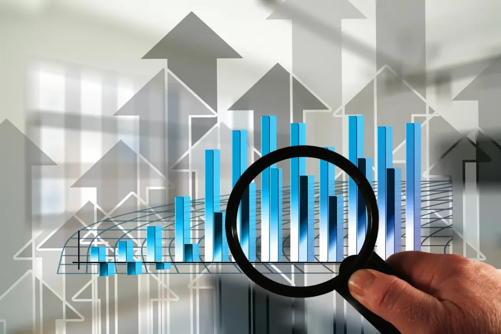 a magnifying glass used to examine a chart showing business growth