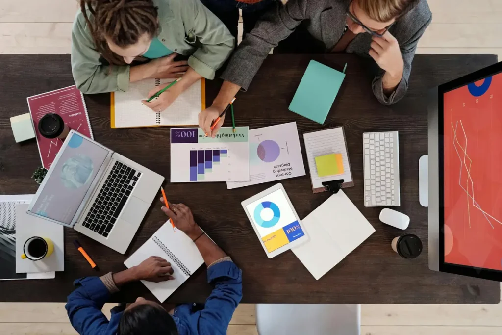 a group of people pouring over charts and data to help with decision making