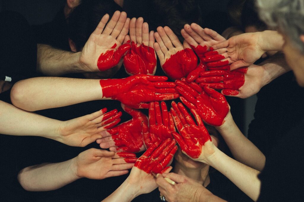 palms joined together to form a canvass for a red heart, a metaphor that self-aware leadership earns the love and respect of team members
