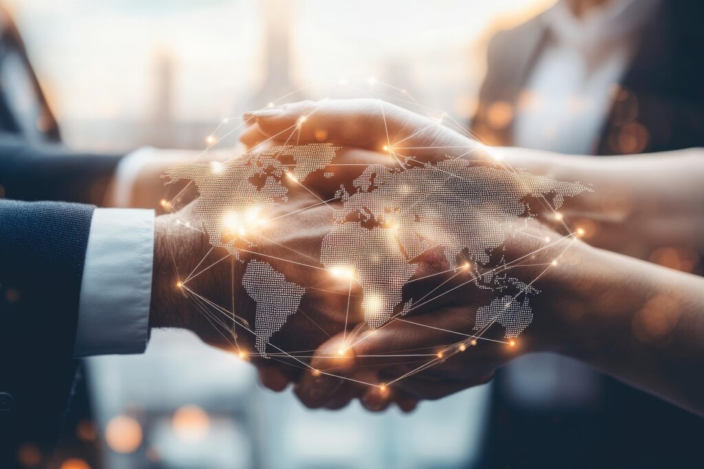 Two business professionals shaking hands, symbolizing partnership and international business acquisition, with a glowing digital world map overlay representing global connections.